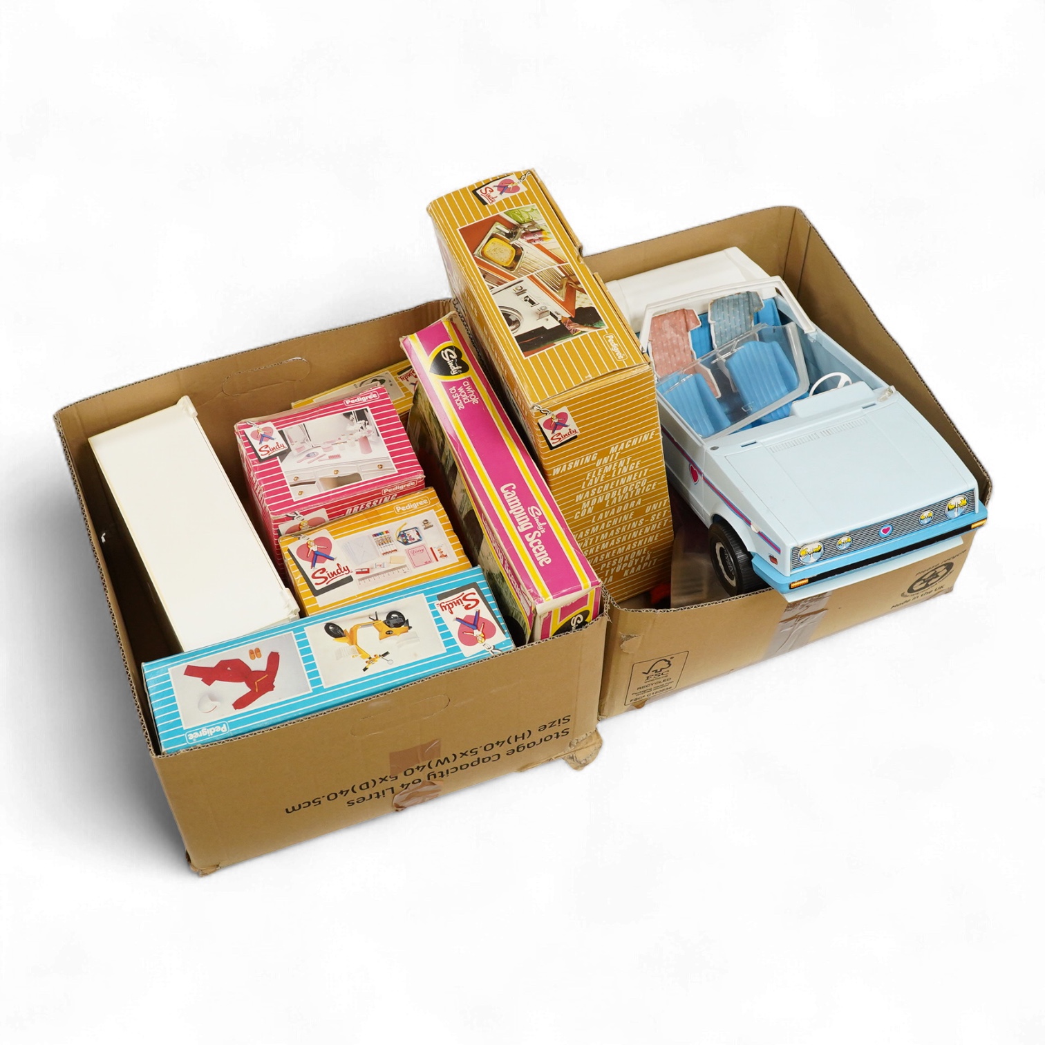 A collection of boxed Sindy doll furniture and accessories, including; a motorcycle (44384), a writing bureau (44512), a hostess trolley, a dressing table, a camping scene, a washing machine unit, together with boxed ite